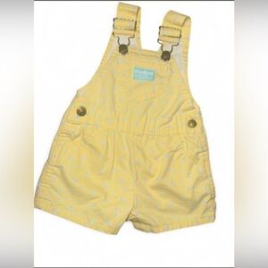 OshKosh B'gosh yellow floral overalls.